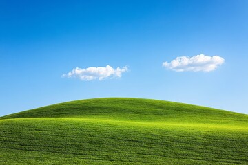 Obraz premium Picturesque Green Hill Under a Vivid Blue Sky with Fluffy Clouds