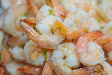 boiled red-pink shrimp with greens are scattered in a pile. High quality photo