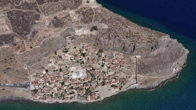 Drone scene showing the landscape of Monemvasia town in Greece by the sea on a sunny day