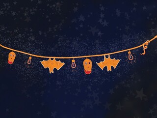A Halloween garland featuring skulls, bats, lightbulbs, and a snake, set against a nighttime background. 