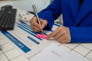 Naklejka premium businesswoman is working in her private office with a lot of paperwork, head of marketing and financial department, an entrepreneur, meeting room, a lot of paperwork on the desk