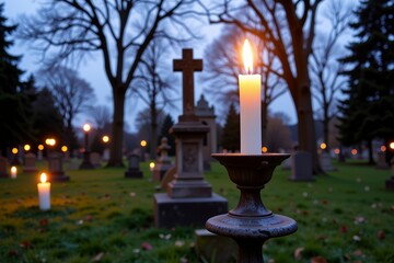 Naklejka premium Illuminated Candle on a Gravestone in a Twilight Cemetery