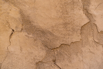 old brown cement rupture wall or top view table ancient yellow paint surface to cracked concrete golden soil for texture rough floor background retro backdrop construction to antique vintage wallpaper