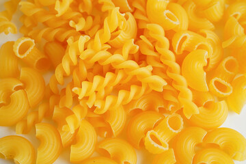 Pasta noodles for cooking Italian food in plastic bag on white background.
