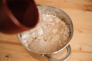 water with flour, preparing bread dough