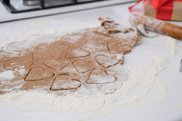 woman making heart shaped cookies in the kitchen