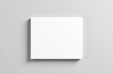 Fototapeta premium A single blank white square card placed neatly on a clean, soft gray background
