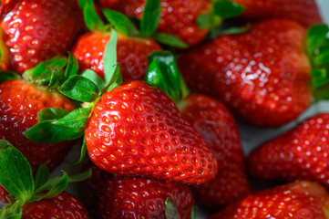 Freshly picked strawberries glistening under the sunlight in a vibrant farmers market setting
