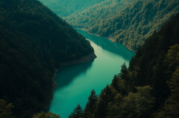 Beautiful mountain landscape with a turquoise lake and forest trees, the mirror reflection of the mountains in the water.