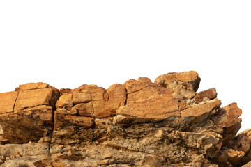 A sunlit rock cliff isolated against a white background. The sun casts warm tones and shadows across the rocky surface, highlighting its layered texture and natural beauty