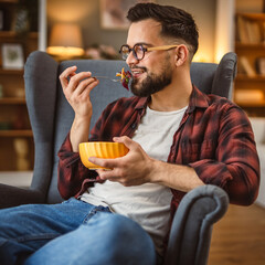 adult man sit at armchair and eat salad healthy lifestyle concept