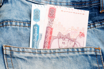 Myanmar kyat in the pocket of blue jeans