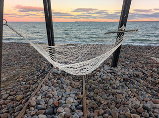 A rope hammock on a wild Baltic Sea beach. A perfect place to relax surrounded by nature even in the off-season.