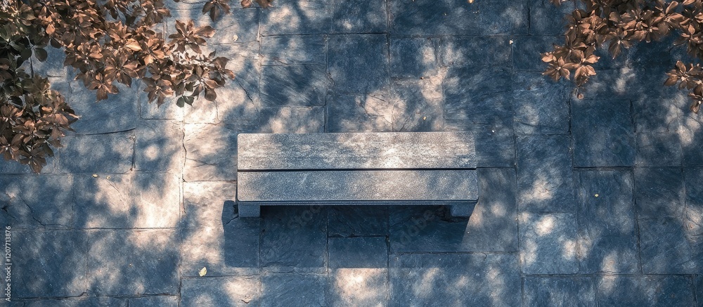 Aufkleber high angle view of grey stone bench on blue pavement in tranquil park surrounded by greenery with su