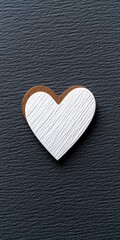 Obraz premium A stylish wooden heart decor piece on a dark textured surface.