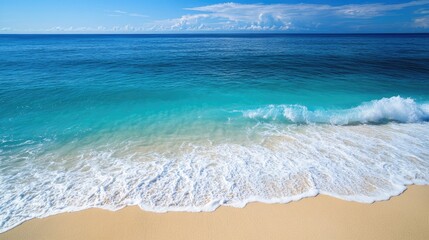 Aerial view of vibrant blue ocean waves crashing on golden sandy shore illustrating coastal beauty with clear space for text placement