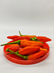 Small chili. Cayenne pepper on a red container.