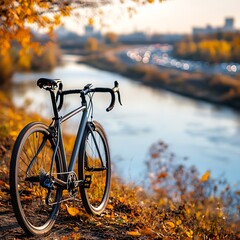 Naklejka premium pollution environment mitigation A sleek bicycle resting near a riverbank adorned with autumn foliage.