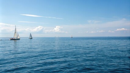 Fototapeta premium Blue sea surface with a few sailboats on the horizon, calm waters, ocean waves, aquatic landscape