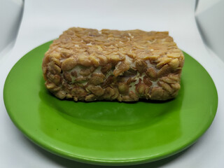 Soybean tempeh. Tempeh is a typical Indonesian food made from fermented soybeans mixed with yeast.