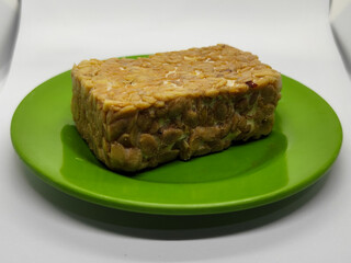 Soybean tempeh. Tempeh is a typical Indonesian food made from fermented soybeans mixed with yeast.