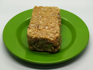 Soybean tempeh. Tempeh is a typical Indonesian food made from fermented soybeans mixed with yeast.