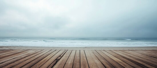 Misty beach landscape with wooden deck and tranquil ocean horizon ideal for adding customized text or messages