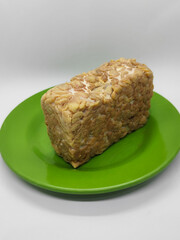 Soybean tempeh. Tempeh is a typical Indonesian food made from fermented soybeans mixed with yeast.