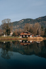 Obraz premium wooden house by the lake near the mountains in France