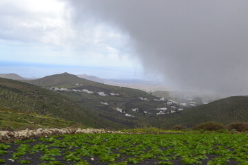 Cloud rolling in over a mountain