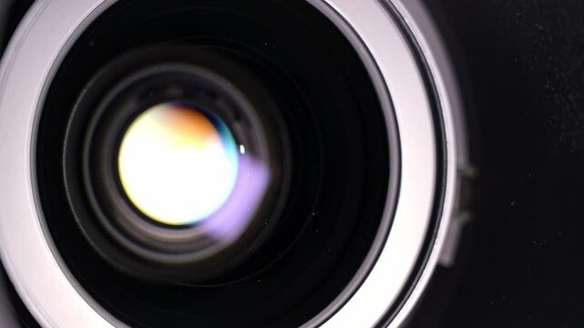 Zoom lens movement close up with light reflections.