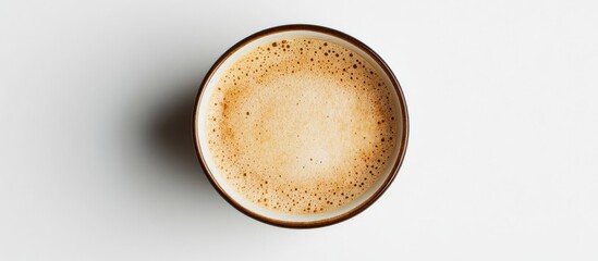 Aerial View of Freshly Roasted Coffee Cup with Creamy Foam on Minimalist White Background Providing Empty Copy Space for Text and Branding