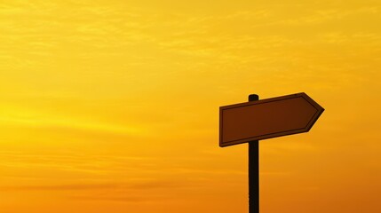 Warm sunset light casts a golden glow over a home for sale, featuring a blank signpost, evoking a real estate concept.
