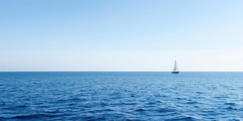 Fototapeta premium Calm blue ocean surface with sailboat sailing in the distance, leisure, calm sea, sailing