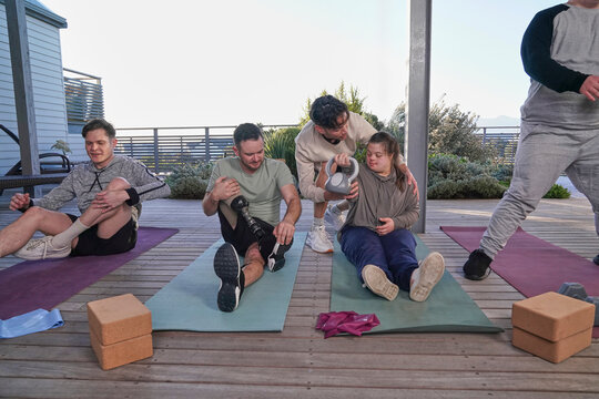 Disabled friends exercising on patio