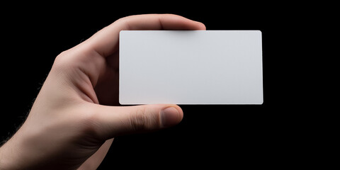 Hand holding blank business card, dark background