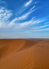 red sand dunes and blue sky in erg chebbi desert, Morocco