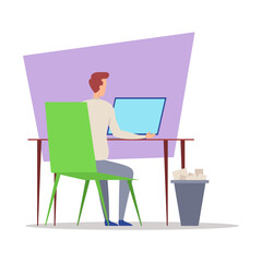 Person sitting at chair while using laptop on desk. Trash bin filled with paper nearby, indicating a busy workspace