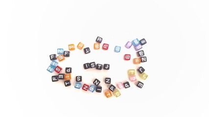 Scattered colorful plastic cubes, focus on the letters ISTJ in the center. The foreground and...
