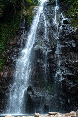 Fototapeta premium Powerful Waterfall Flowing Over Rocky Cliffs
