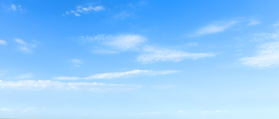 Fototapeta premium Vast blue sky with wispy cloud trails, dreamy feel
