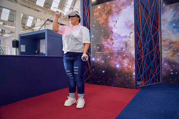 Teenager using virtual reality simulator at science center