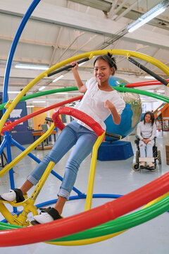 Teenager on gyroscope in science center