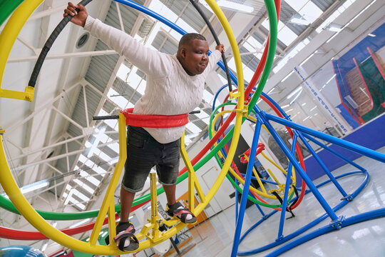 Teenager with cerebral palsy on gyroscope in science center