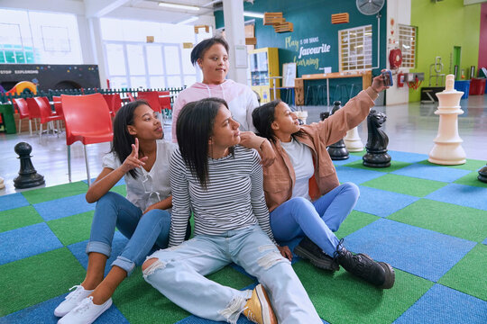 Children taking selfie on chess board at science center