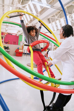 Girl having fun on gyroscope at science center
