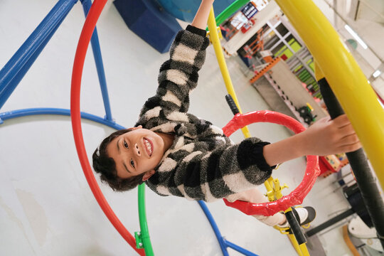 Boy having fun on gyroscope at science center