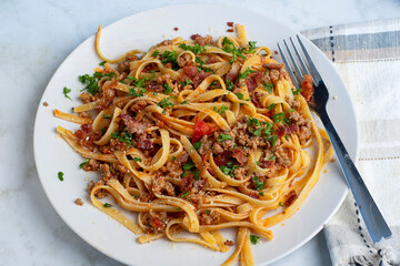 linquine  top with crumble  sausage, bacon  bits and parsley