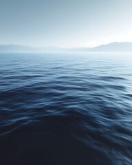 Fototapeta premium Serene ocean view, calm water, misty mountains.