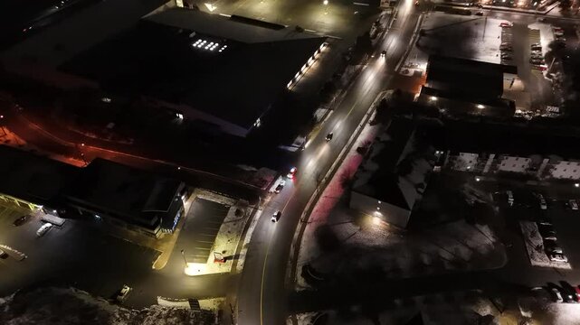 A Police Officer Stops Traffic At Night In An Urban Industrial Area. Aerial View Captures The Tense Moment As The Officer Approaches The Driver To Check Documents, Adding Suspense To The Scene.